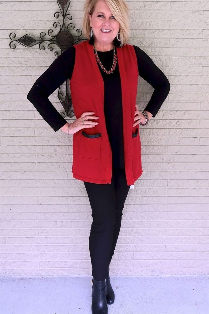 A ruby red vest adds a punch of color to a simple all black base.