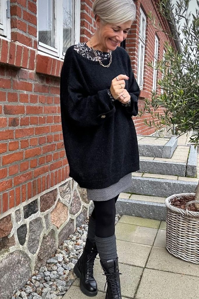 An oversized sweater layered over a houndstooth mini dress feels cozy and edgy at once.
