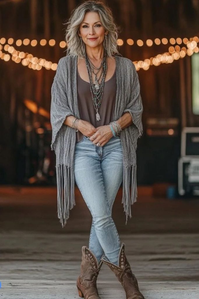 A fringe shawl and layered necklaces bring boho rock energy to simple skinny jeans.