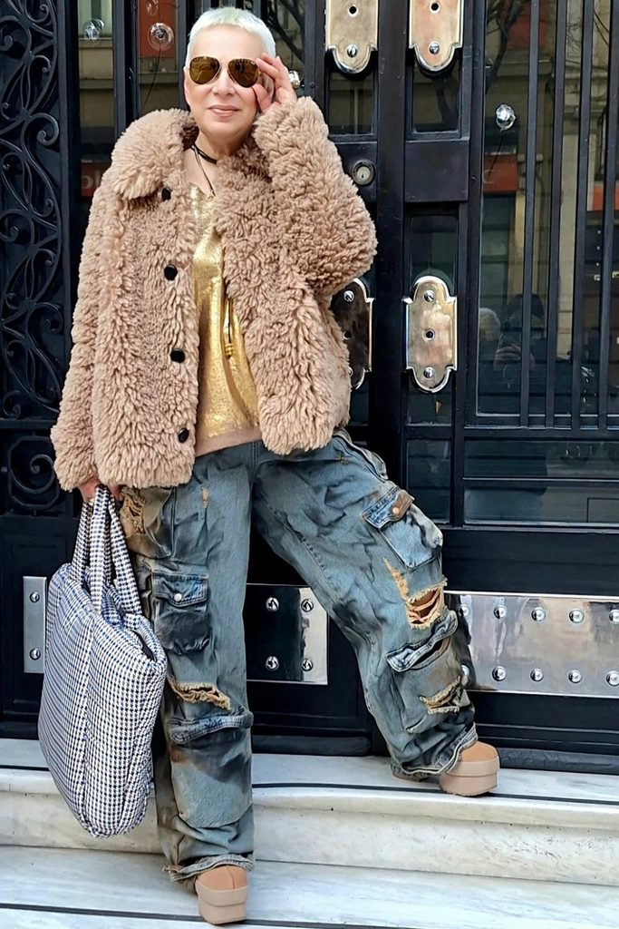 A textured teddy coat and distressed cargo jeans mix cozy and rebellious in one look.