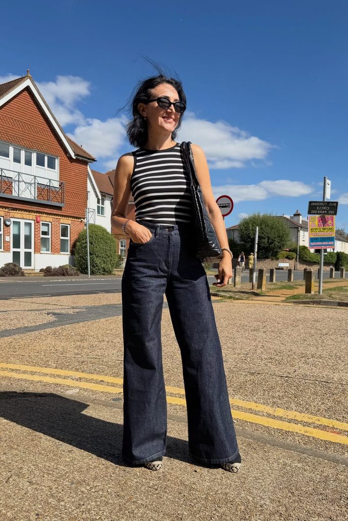 A classic striped tank keeps wide leg raw denim trousers feeling casual and cool.